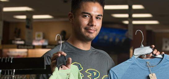 Student holding clothing.